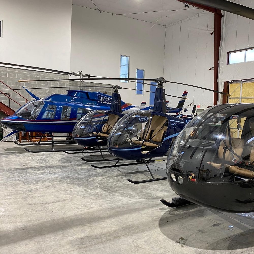 Helicopters lined up in a hangar